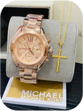 Michael Kors wristwatch paired with a gold cross pendant necklace